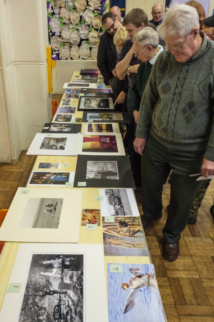 Reflex Camera Club members looking over the entries in a 'just for fun' competition that was held