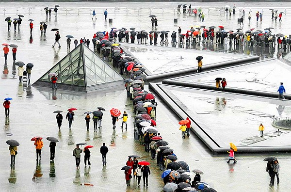 Queuing in the Rain by Ann Miles